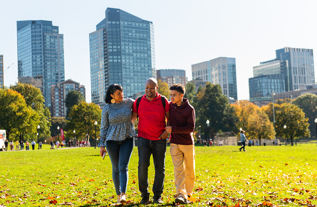 Family walking at Boston Commons during fall